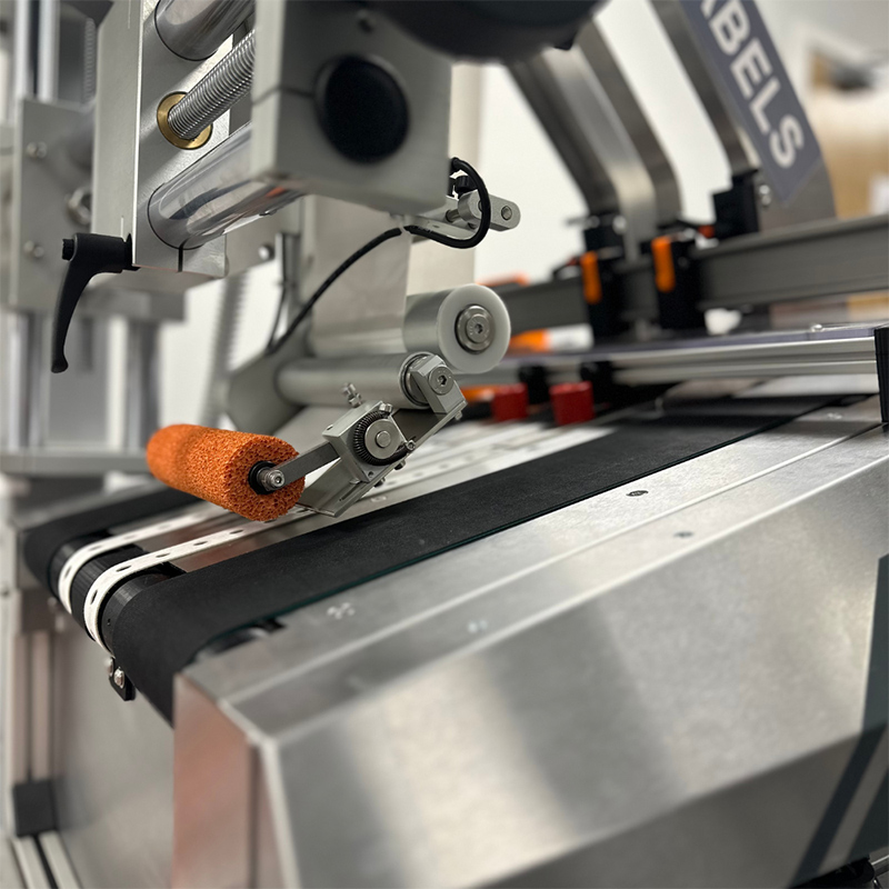 The feeder labeller, a unique combination of a wipe-on label applicator and automatic packet feeding system, is now available from AM Labels Limited