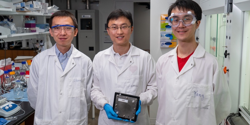 Rice University researchers – from left, Chuan Xia, Haotian Wang and Yang Xia – show a scaled-up hydrogen peroxide reactor that makes the valuable chemical using just air, water and electricity. Their work appears in the journal Science. (Credit: Brandon Martin/Rice University)