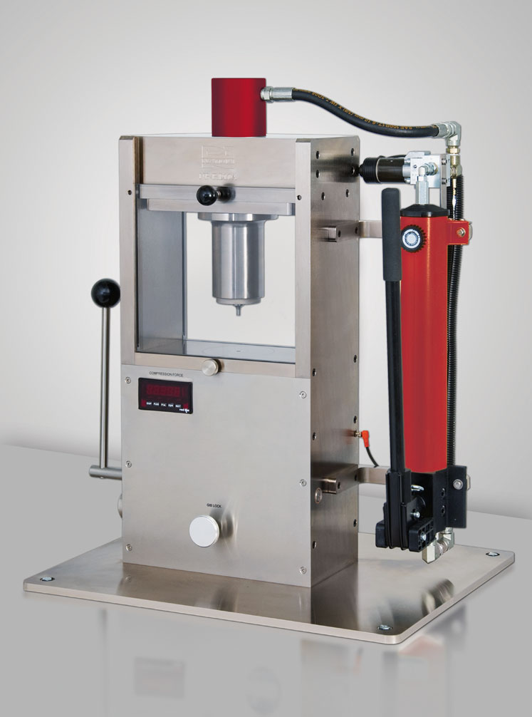 Figure 1: An example of a single-station tablet press (NP-RD10A) that uses single-ended hydraulic hand-pump compression