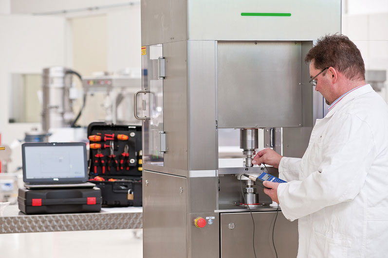 A tableting mixture is weighed for small-scale trials in the fully furnished KiTech laboratory