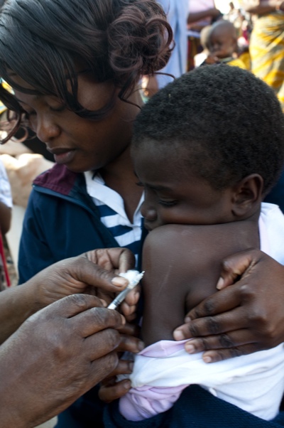 A child receives a life saving vaccine at a health clinic in Zambia. The public health sector in Zambia registers 100,000 deaths annually due to preventable and curable diseases, often because of challenges in getting drugs to remote clinics. Photo Credit: UNICEF Zambia