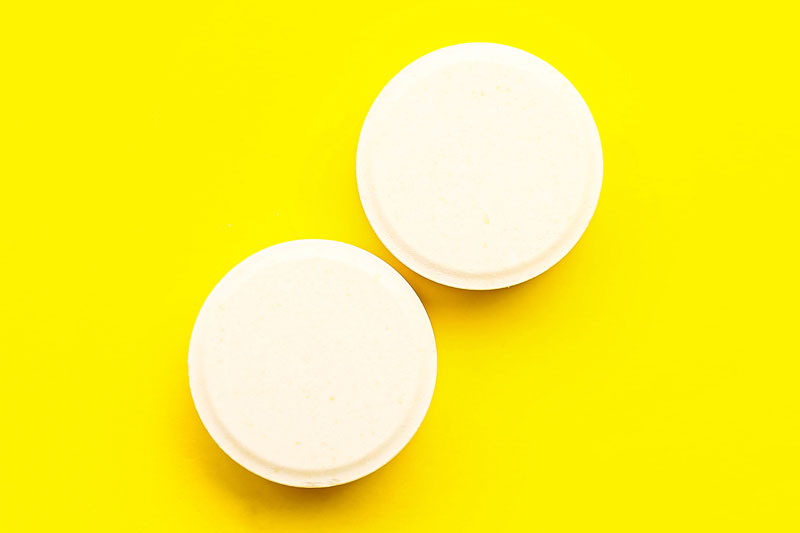 Coating coin-shaped cores: a downstream technology solution to reduce tablet capping