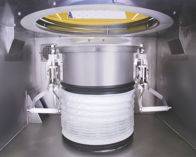 Discharger dust hood contains bag spout leaks